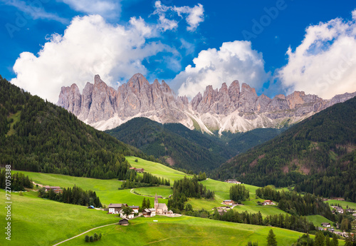 Dolomite mountains in summer with a green valley © Maresol
