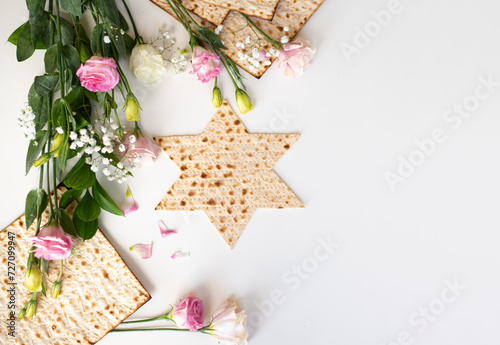 Passover. banner of Traditional Matzo shape of star Magen David  decorate by pink flowers on white background. top view. Holiday of Jewish people, Spring Holiday. Fasting time