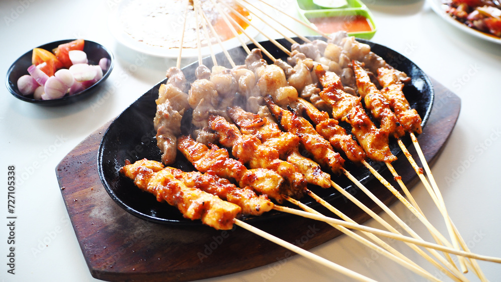 Delicious culinary Indonesian Food, chicken satay and goat satay in the barbecue plates