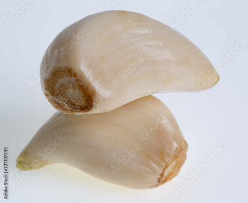 Two garlic cloves on white 