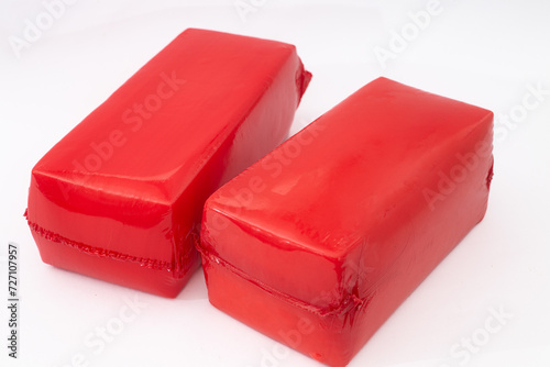 Two cheeses in red shrink bags  on white 