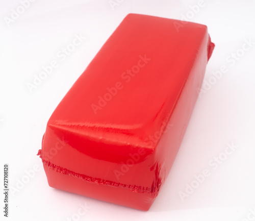 Cheese in red shrink bag  on white 