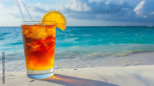 Refreshing bahama mama cocktail in tropical setting with blurred beach background and copy space