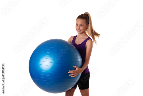 Slim and fit teen girl holding a swiss blue ball. Shot on white background.