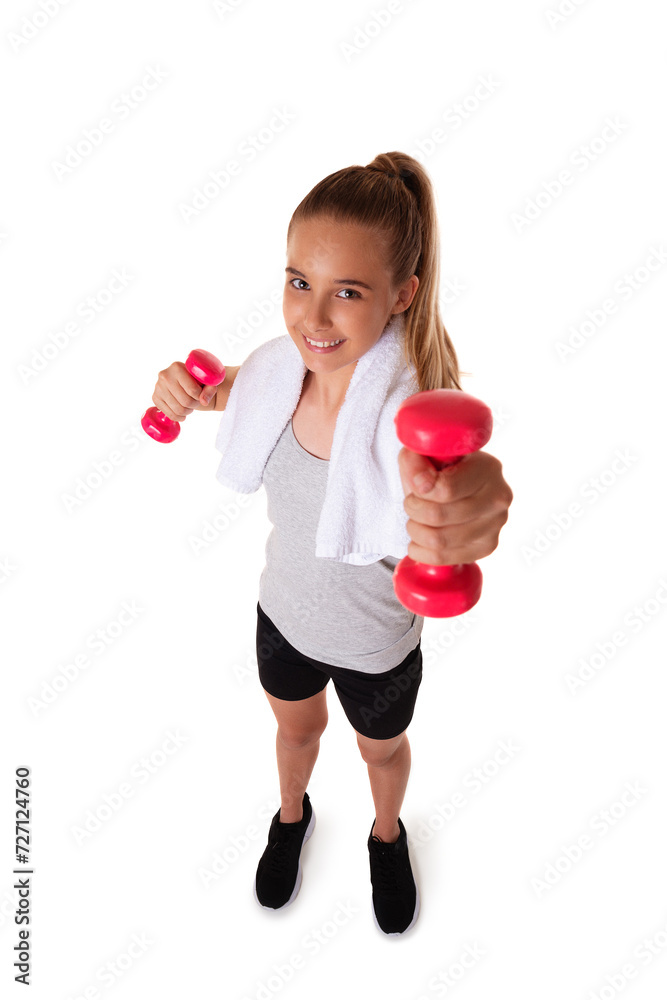 Healthy teen girl with dumbbells working out with towel on shoulder. Isolated on white background. fitness gym concept. Wide angle shot Healthy teen girl with dumbbells working out with towel on shoulder. Isolated on white background. fitness gym concept. Wide angle shot