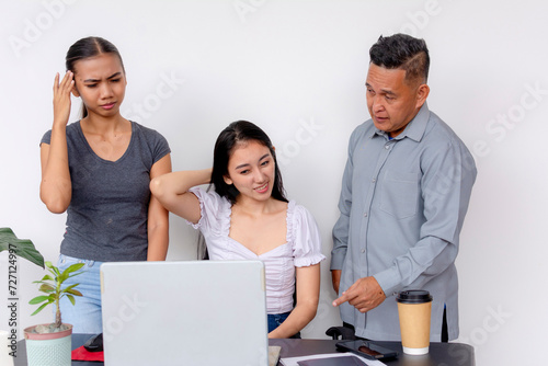 An older stubborn and overbearing man tells two frustrated women what to do, applying his seniority, despite his lack of knowledge. Concept of mansplaining, patronizing supervisor, or abuse of power.