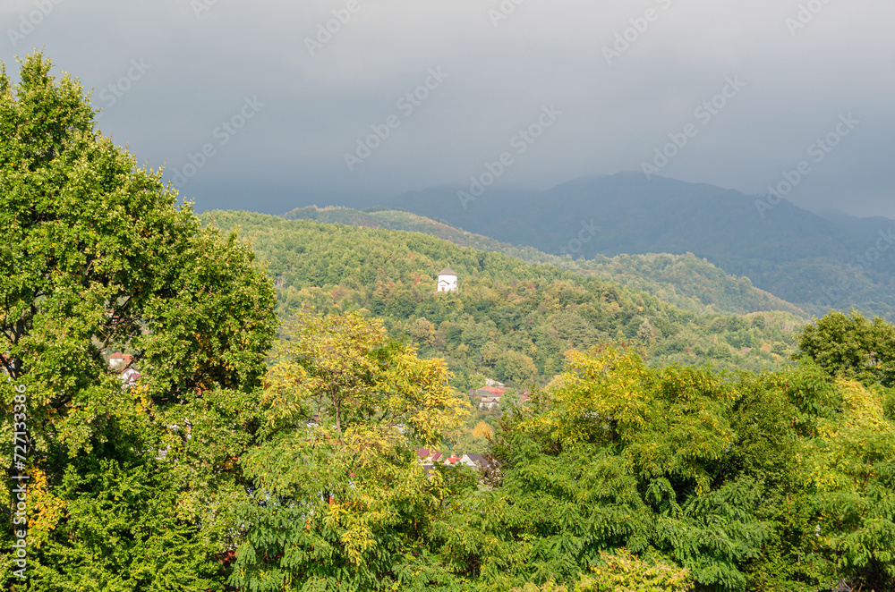 White chapel on a hill in autumn