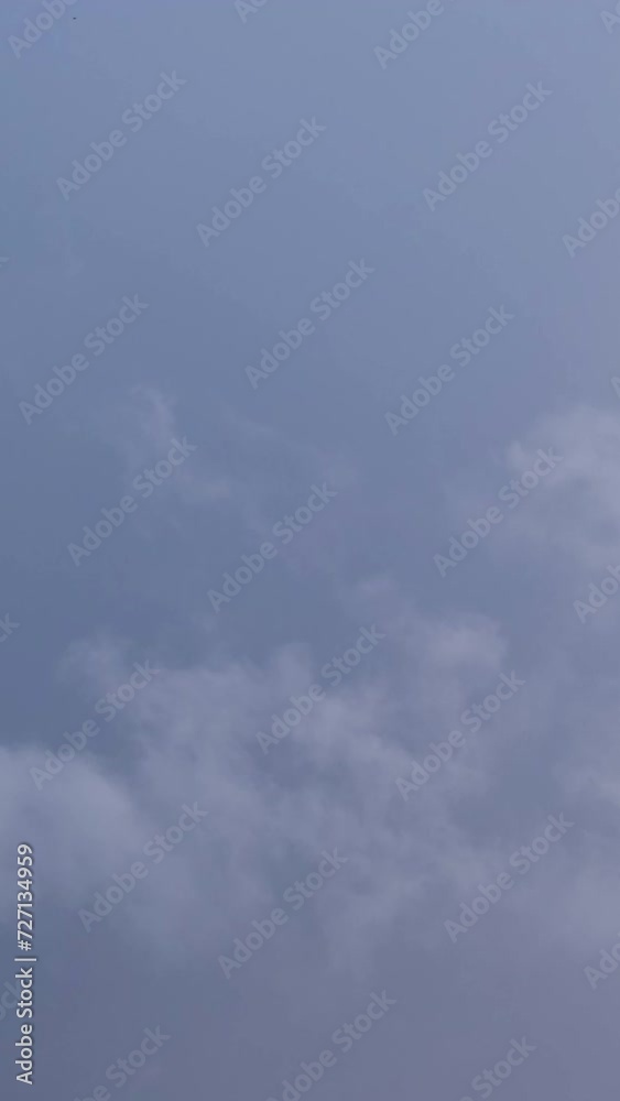 Close-up of fluffy white clouds moving quickly against the dark blue stormy sky. Magnificent dramatic nature on a windy autumn morning. Relaxing or meditative, continuously changing cloudscapes. Close-up of fluffy white clouds moving quickly against the dark blue stormy sky. Magnificent dramatic nature on a windy autumn morning. Relaxing or meditative, continuously changing cloudscapes.