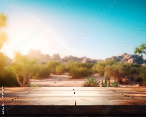 Empty wooden table mockup with defocused mesmerizing desert sunset, dunes, and a lush oasis.