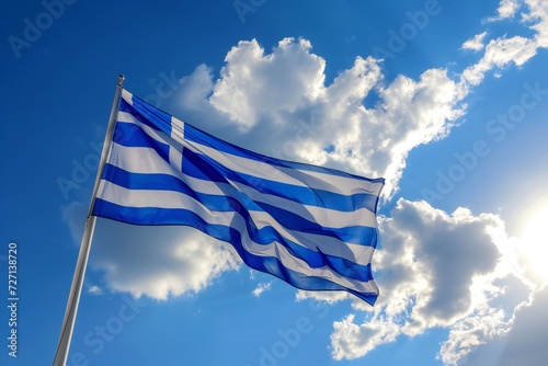 The national flag of Greece on a background of blue sky in the windy summer afternoon. independence day in Greece
