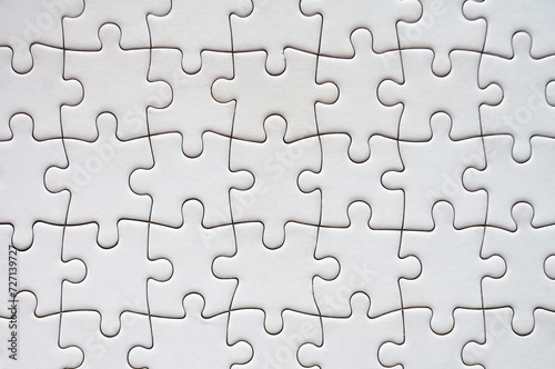 Top view of white jigsaw puzzle. Gaming concept