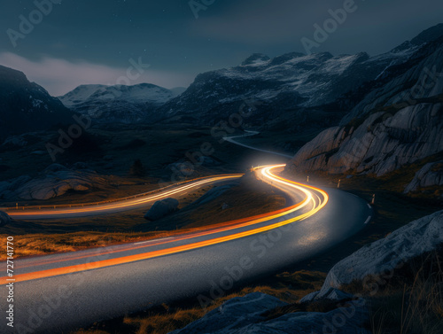 A road through a mountain landscape at night with bright light trails.