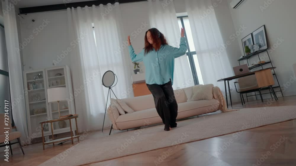 delighted woman with red hair dancing in apartment happy independent lifestyle delighted woman with red hair dancing in apartment happy independent lifestyle