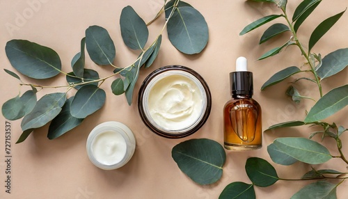 flat lay composition with natural organic cosmetic products on beige background top view hand cream in jar essential oil skin lotion and eucalyptus leaves natural organic beauty product concept