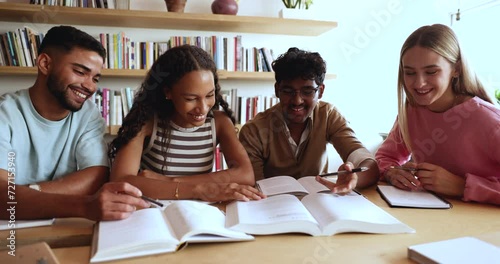 Laughing multi-ethnic schoolgirls and schoolboys talking, studying together, learn theory and new topic, read textbooks engaged in group class in library. New knowledge, skills development, education photo