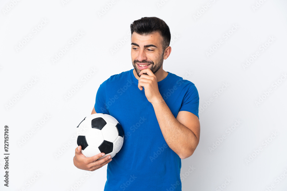 Handsome young football player man over isolated wall looking to the side and smiling Handsome young football player man over isolated wall looking to the side and smiling