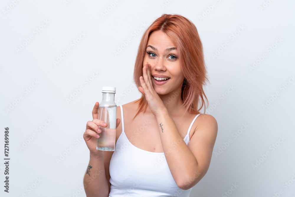 Young Russian girl with a bottle of water isolated on white background whispering something Young Russian girl with a bottle of water isolated on white background whispering something