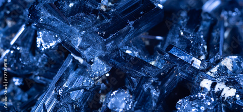 Blue Crystal Mineral Stone. Gems. Mineral crystals in the natural environment. Texture of precious and semiprecious stones. Seamless background with copy space colored shiny surface of precious stones photo