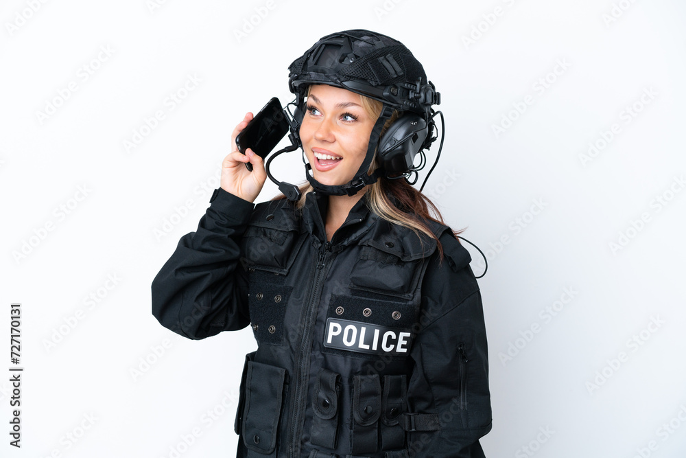 SWAT Russian woman isolated on white background keeping a conversation with the mobile phone SWAT Russian woman isolated on white background keeping a conversation with the mobile phone