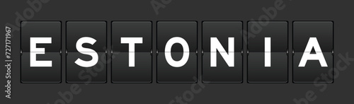 Black color analog flip board with word estonia on gray background