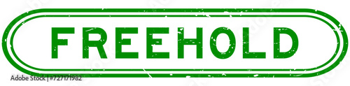 Grunge green freehold word rubber seal stamp on white background