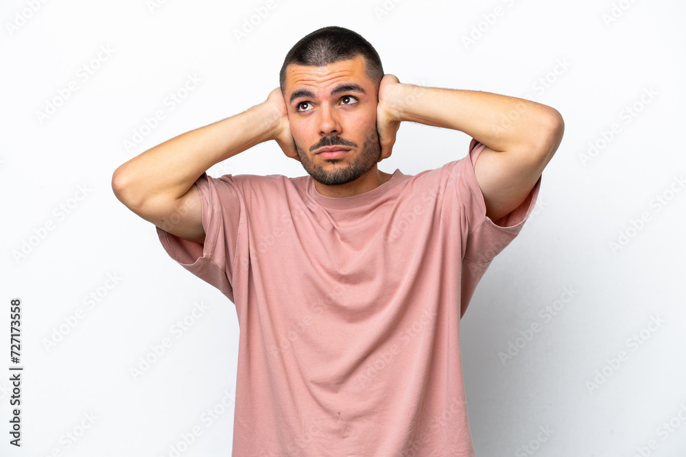Young caucasian man isolated on white background frustrated and covering ears Young caucasian man isolated on white background frustrated and covering ears