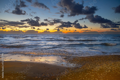seashore with dramatic clouds at sunset in Haifa