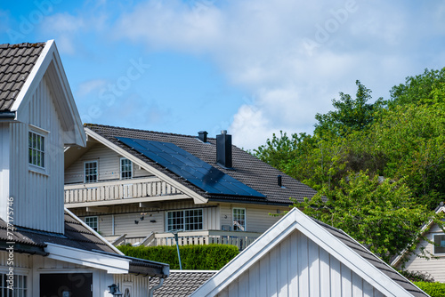 Solar cells mounted on rhe roof of a house. photo