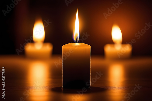 Three burning candles creating a warm and cozy ambiance in a dark, serene setting