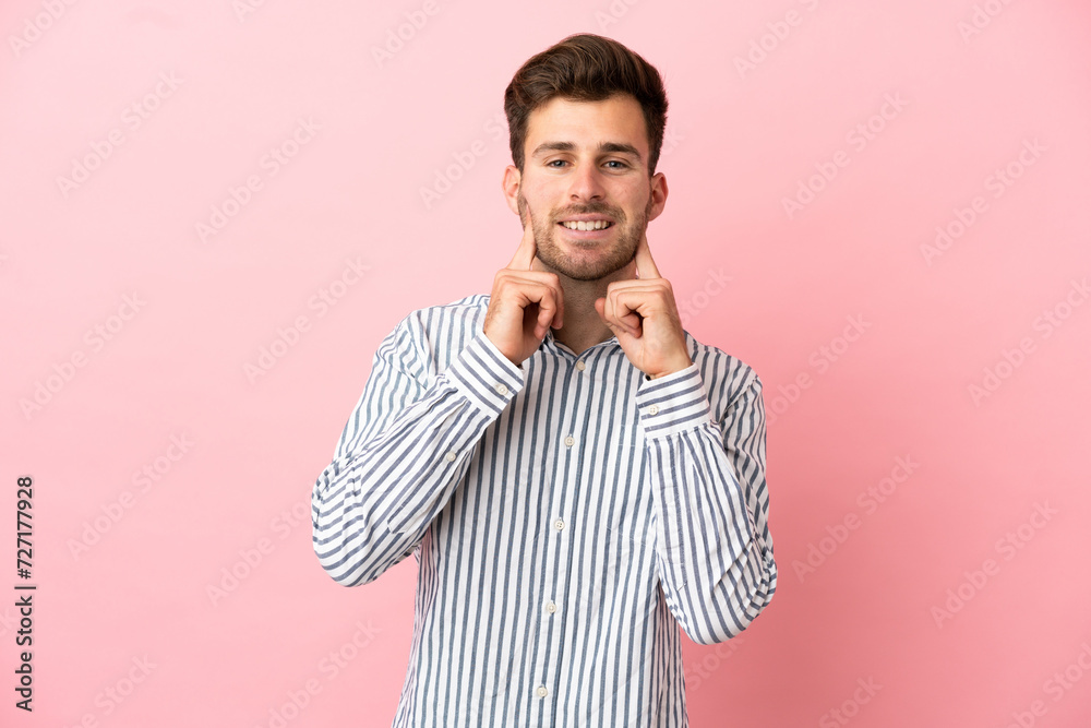 Young caucasian handsome man isolated on pink background smiling with a happy and pleasant expression Young caucasian handsome man isolated on pink background smiling with a happy and pleasant expression
