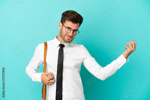 Business man over isolated background making guitar gesture