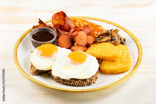 Fried eggs with bbq sausage and mushrooms. Βreakfast concept.