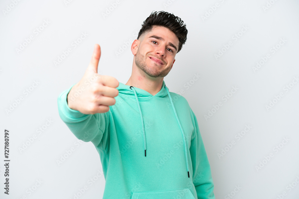 Young caucasian man isolated on white background with thumbs up because something good has happened Young caucasian man isolated on white background with thumbs up because something good has happened