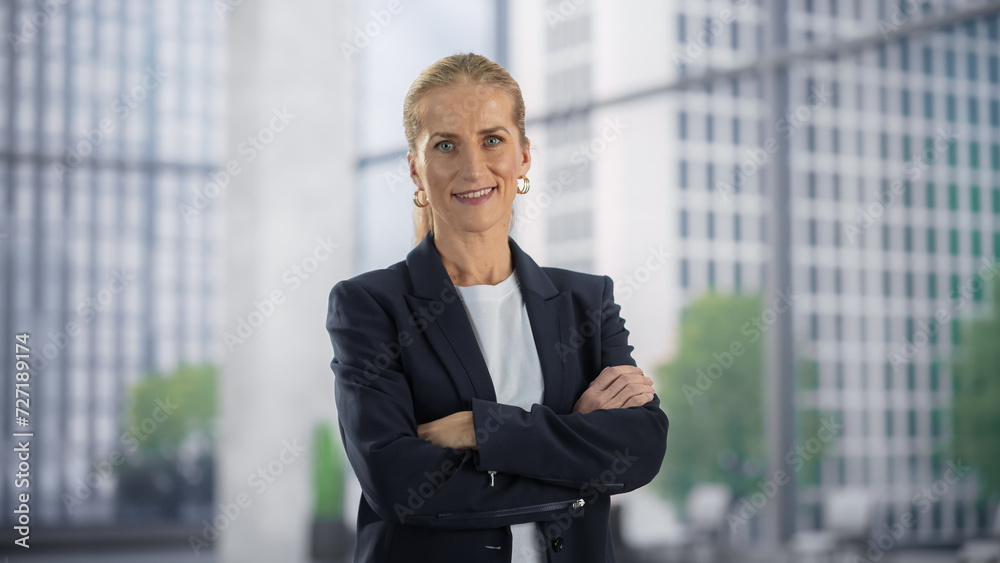 Portrait of a Beautiful Caucasian Businesswoman Posing in Big City Office Building. Adult Female Manager Smiling, Looking at Camera. Successful Business Specialist at Work Portrait of a Beautiful Caucasian Businesswoman Posing in Big City Office Building. Adult Female Manager Smiling, Looking at Camera. Successful Business Specialist at Work