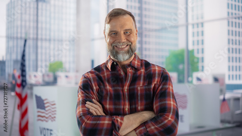 Portrait of a Handsome Caucasian Working Class Man Posing with American Flag in the Background. Successful Adult Masculine Male Smiling, Looking at Camera, Holding Arms Crossed