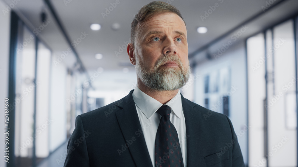 Portrait of a Confident Businessman Walking To His Office in a Bright Business Center: Successful Senior Manager with Serious Face Expression Walking to Workplace in the Morning Portrait of a Confident Businessman Walking To His Office in a Bright Business Center: Successful Senior Manager with Serious Face Expression Walking to Workplace in the Morning