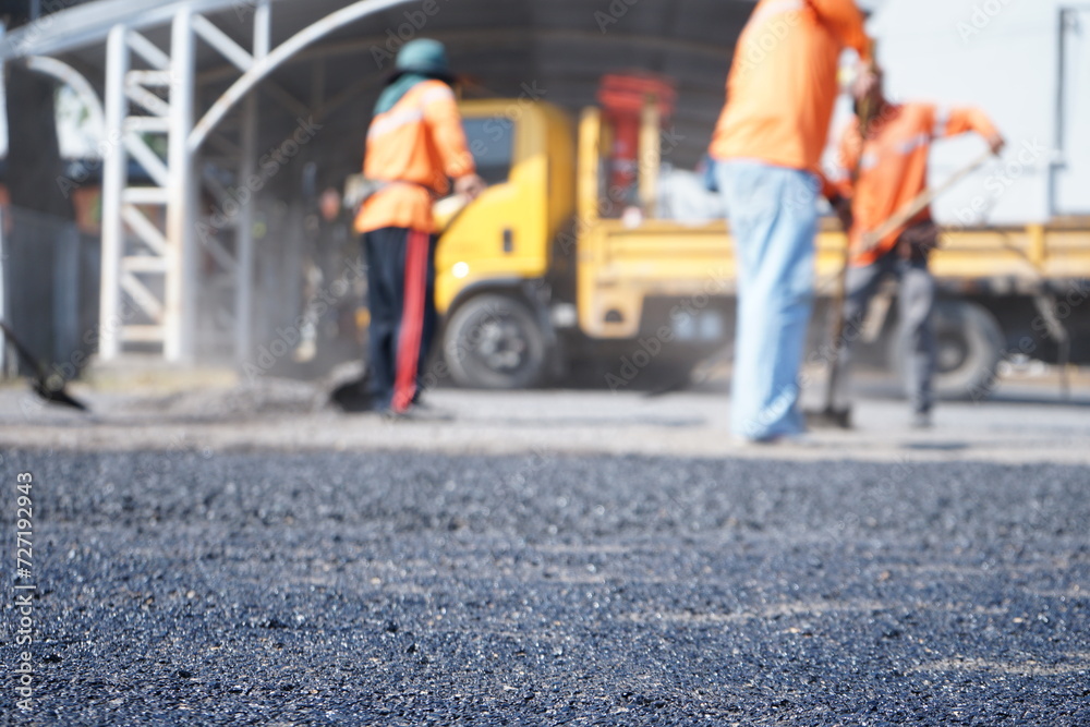 Fototapeta premium Blurred image of pavement maintenance work using human labor