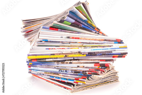 Stack of old paper magazines isolated on white background