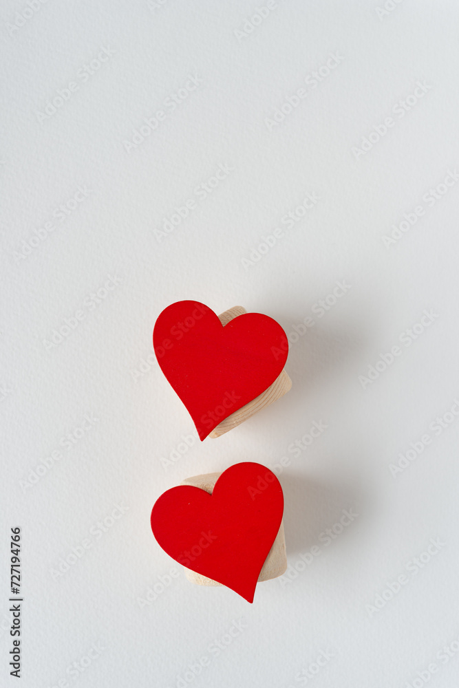 two red hearts on wooden objects