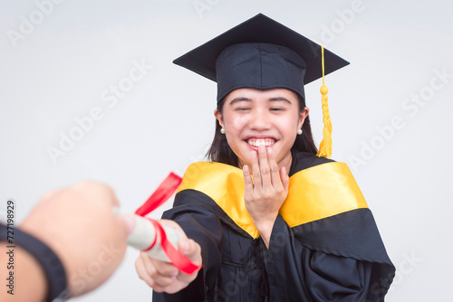 An ecstatic female graduate of bachelor of science is handed her diploma. Full body photo isolated on a white background. photo