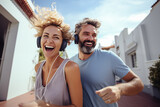 Adult couple at outdoors listening music with headphones