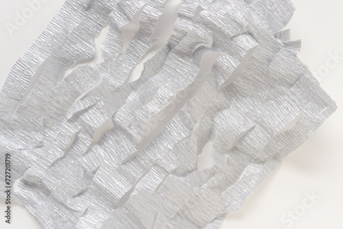 crushed and torn metallic silver crepe paper background