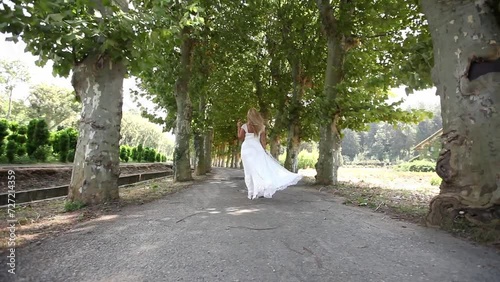 girl walking on a path among trees