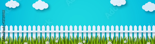 Wooden white fence, flowers and grass. Vector illustration. Sumer banner poster template, place for text. Paper cut clouds in blue spring sky. Chamomile daisy lawn
