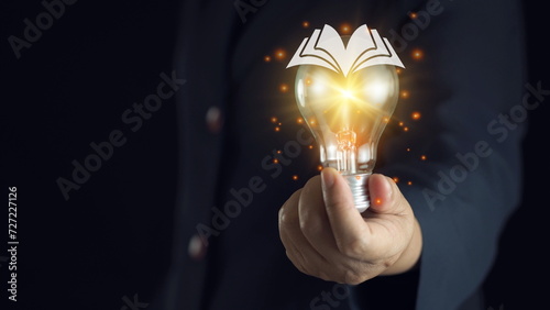 light bulb glowing on book, idea of ​​inspiration from reading, innovation idea concept, Self learning or education knowledge and business studying concept. photo
