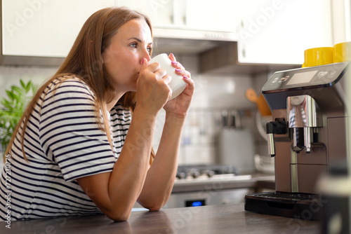 Woman Enjoying Morning Coffee in Modern Kitchen