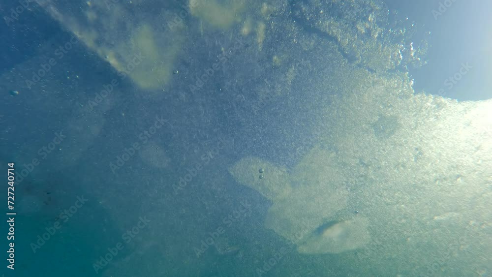 Thin ices sparkling in bright spring sunbeams, slowly floating along coastline, Underwater shot, Slow motion. View from below water of the ice drift. Thin ices sparkling in bright spring sunbeams, slowly floating along coastline, Underwater shot, Slow motion. View from below water of the ice drift.
