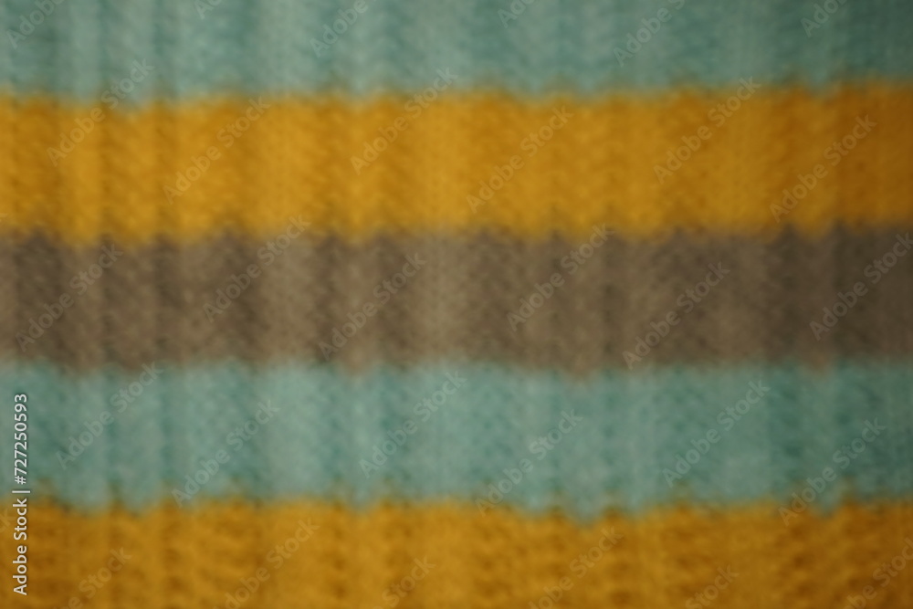 Fototapeta premium Unfocused blurred background with striped blue, gray, yellow threads.
