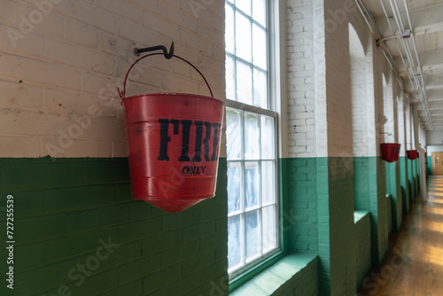 Lowell, Massachusetts: Lowell National Historical Park celebrates the era of textile manufacturing during the Industrial Revolution. Boott Cotton Mills Museum red fire buckets. photo