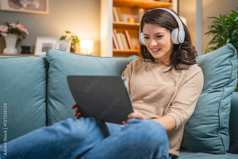 woman sit on the sofa bed watch movie video online use digital tablet woman sit on the sofa bed watch movie video online use digital tablet